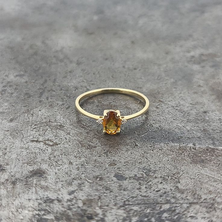 14k yellow gold petite citrine and diamond ring. 0.016cts of diamonds. Finger size 6. Gold Citrine Birthstone Ring With Prong Setting, Classic Citrine Diamond Ring In Yellow Gold, Yellow Gold Citrine Oval Diamond Ring, Oval Citrine Diamond Ring In Yellow Gold, Oval Topaz Birthstone Ring In Yellow Gold, Citrine Diamond Ring With Accent Stones In Yellow Gold, Yellow Gold Citrine Diamond Ring With Accent Stones, Yellow Gold Citrine Diamond Ring With Accents, Yellow Topaz Center Stone Ring In 14k Gold