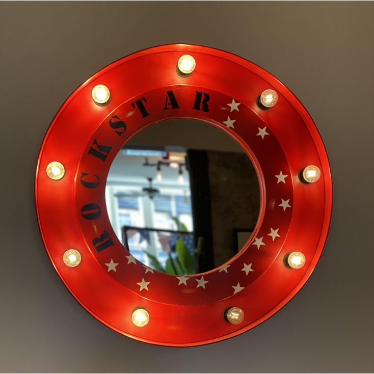 a round mirror with lights around it that says star on the front and back side