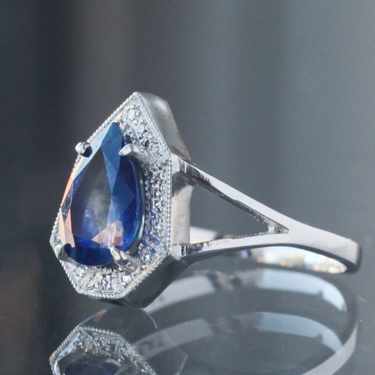 Our classic Phoebe, so beloved because of how her hard exterior frames a softened center, here cradling a 1.79ct ink drop blue sapphire in a brilliant pear cut, highclass spaceship engagement ring to travel through the Borealis particles. A one-of-a-kind beauty, handmade in platinum in our San Francisco Studios by our team of expert jewelers. Currently a size 6.25 and resizable, so please leave your size in the checkout notes! Timeless Polished Sapphire Ring, Sapphire Ring In Yellow Gold With Halo Setting, Elegant Royal Blue Sapphire Ring With Center Stone, Royal Blue Sapphire Ring For Formal Occasions, Classic Teardrop Sapphire Ring, Blue Sapphire Ring With Pear-shaped Center Stone, Classic Teardrop Sapphire Ring For Anniversary, Blue Pear-shaped Jewelry With Polished Finish, Blue Pear-shaped Sapphire Ring With Center Stone