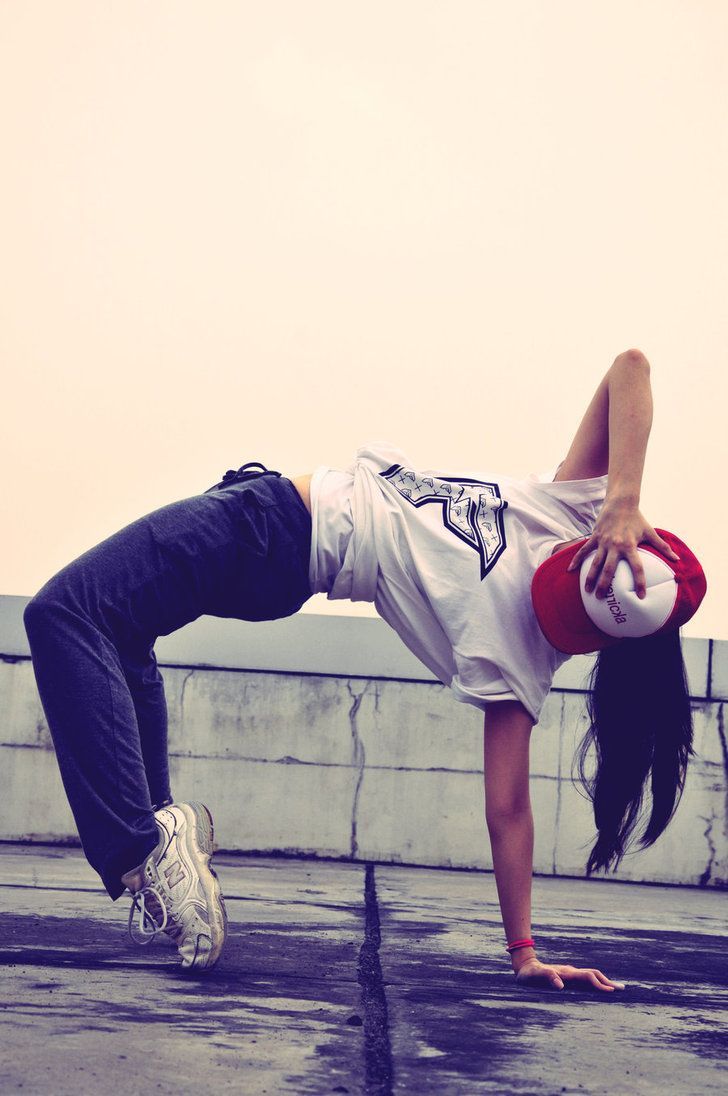 a woman doing a handstand on her skateboard