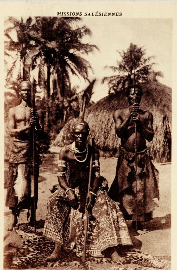 an old black and white photo of two men in native garb standing next to each other