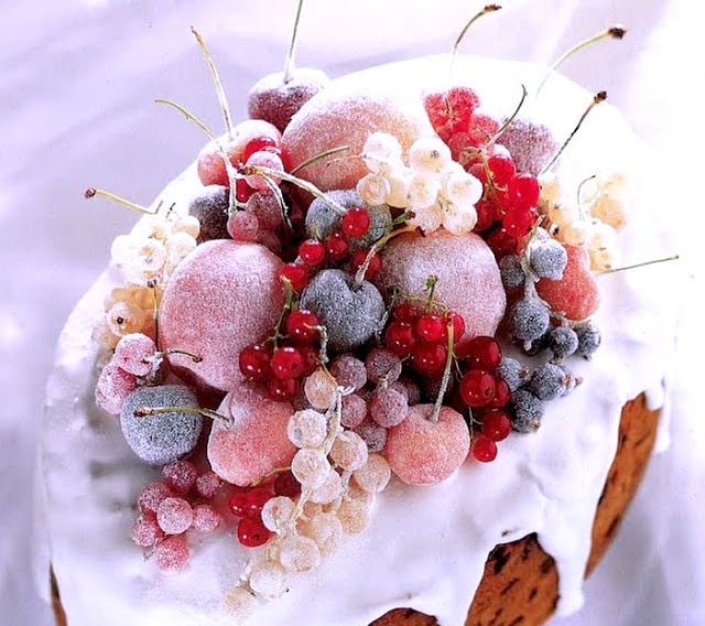 a cake with frosting and berries on top