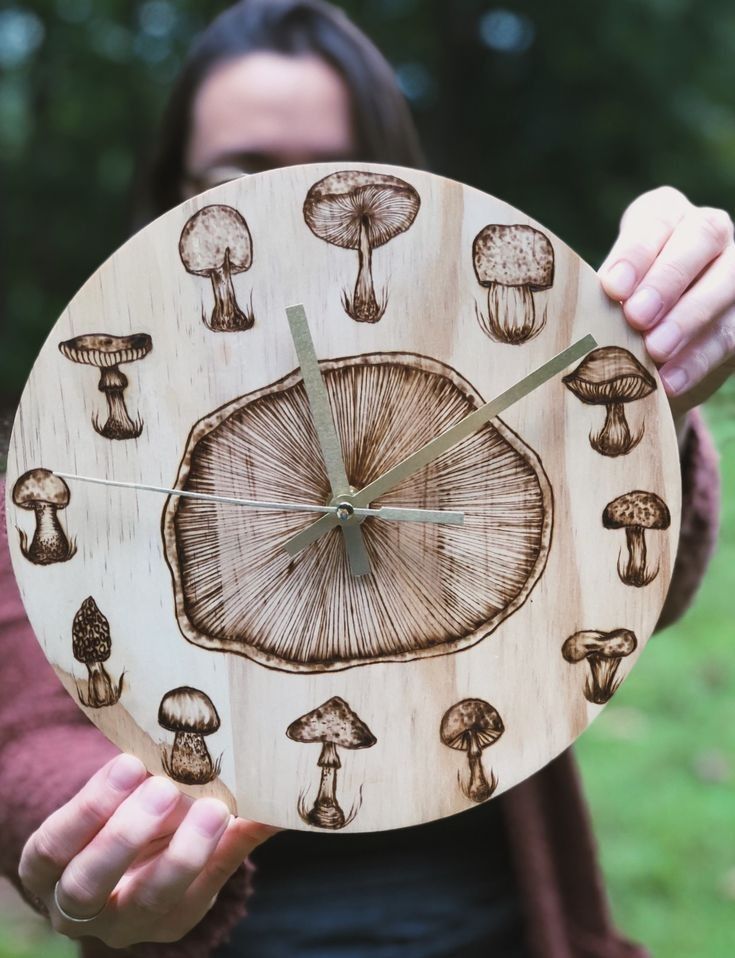 a woman holding up a clock with mushrooms on it