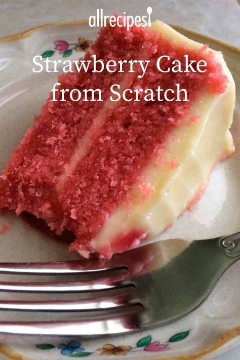 a piece of strawberry cake on a plate with a fork