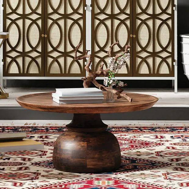 a wooden table sitting on top of a rug