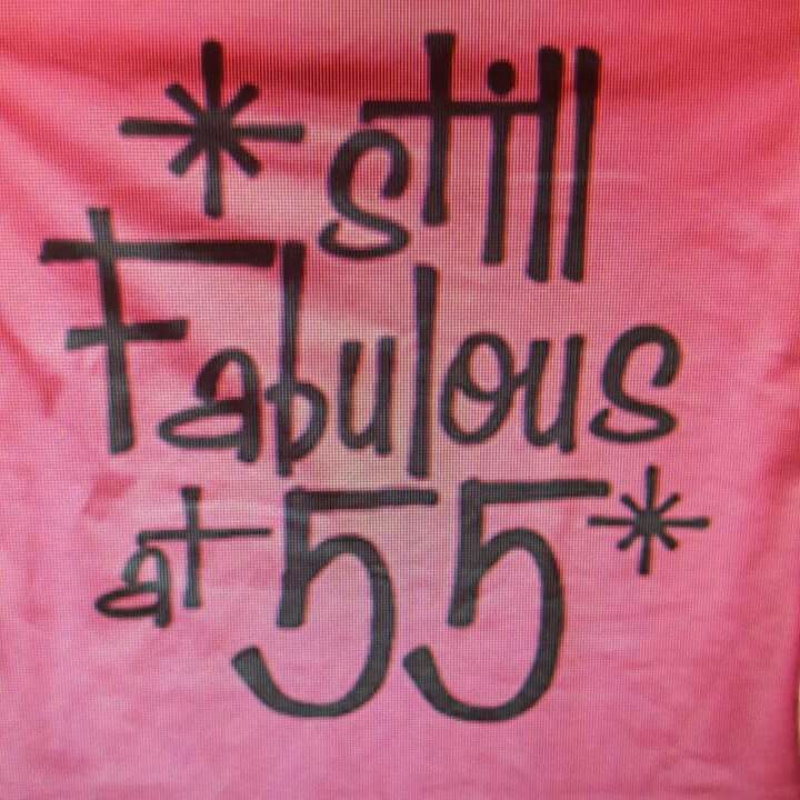 a pink t - shirt with the words fabulous at 55 written in black on it