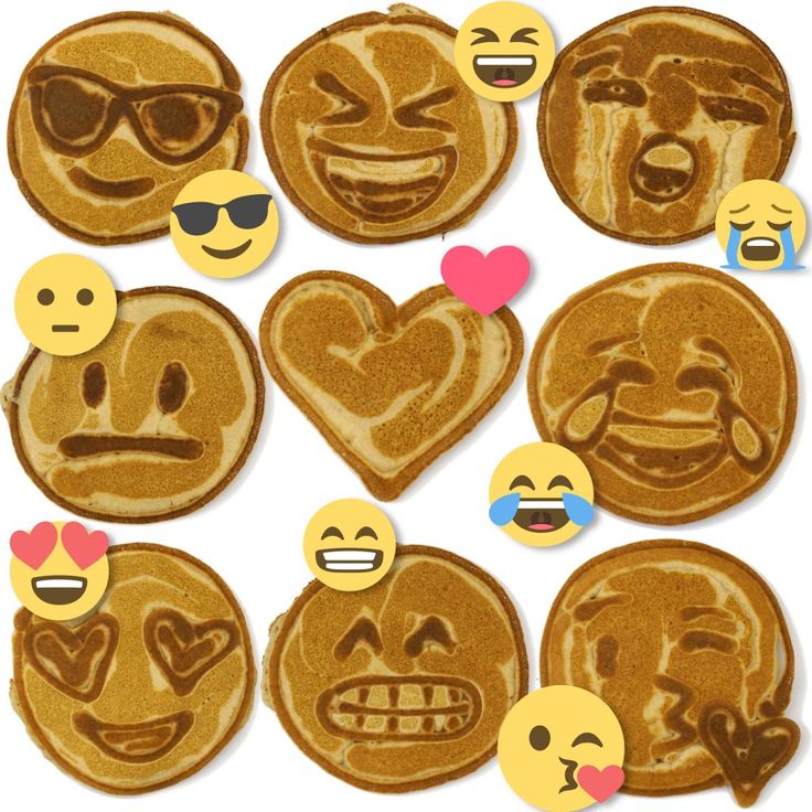 some pancakes with emoticions and hearts on them