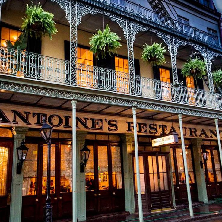 an old - fashioned restaurant is lit up at night in new orleans, florida usa