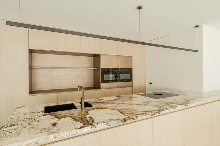 a kitchen with marble counter tops and an oven