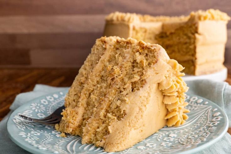 a piece of cake sitting on top of a blue plate with a fork in it