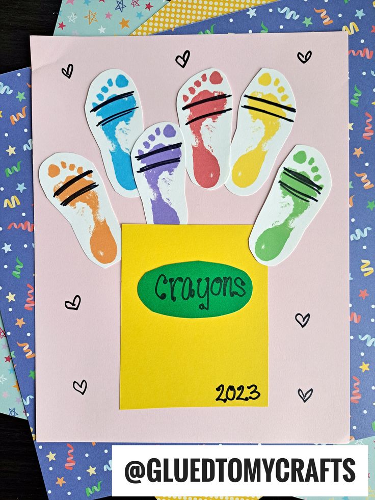 some paper cut outs with the words crayos on them and two pairs of feet