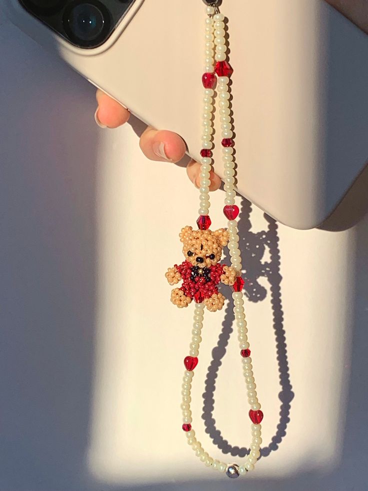 Phone Strap with Rouje (Red Teddy bear), ivory glass beads, heart glass beads. Teddy Bears are all handmade by us:) Length: 6.5~7.5 inches (including loop) Materials: Preciosa Crystal Beads, Glass Beads Rouje the teddy bear<3 Click below for more of our collections. https://www.etsy.com/shop/RebekahJewelry?ref=search_shop_redirect Care Instructions Our charms do not like to get wet nor like sitting out under the sun. Please keep away from all kinds of water/chemical and avoid exposure to heat/su Red Vintage Phone, Beaded Teddy Bear, Y2k Beads, Beaded Bear, Telephone Vintage, Jewels Diy, Vintage Phone, Strap Phone, Diy Embroidery Patterns