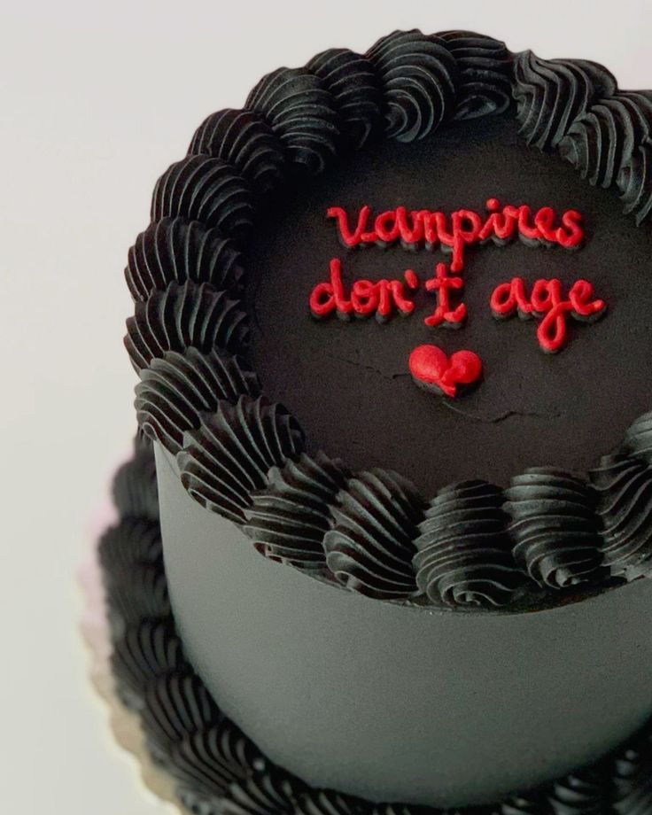 a chocolate cake with the words vampire don't age written on it and red icing