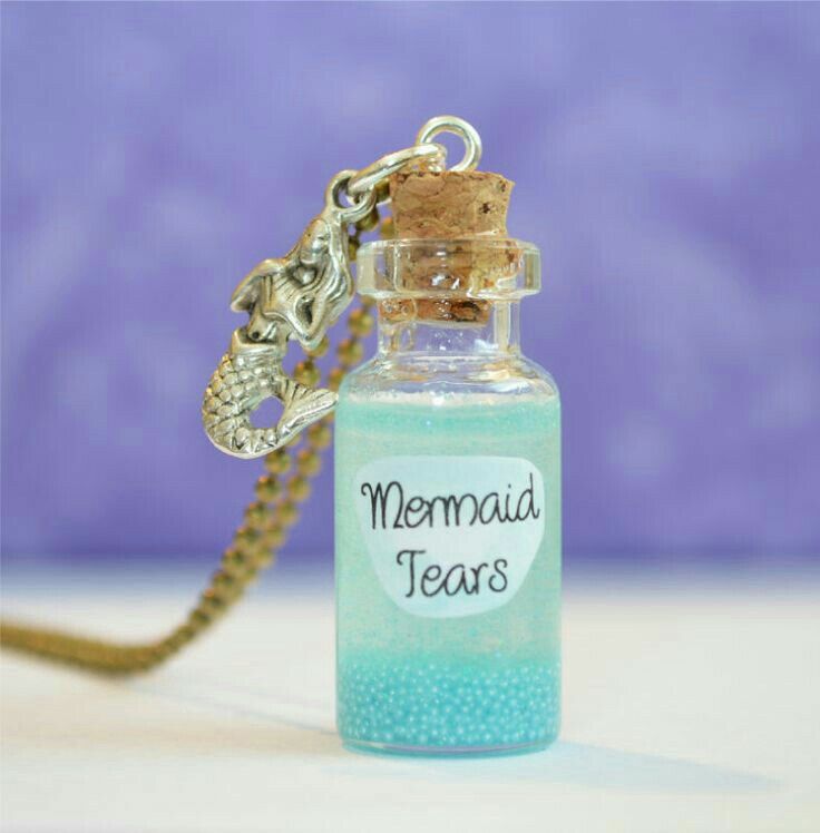 a bottle necklace with a mermaid tears message on it