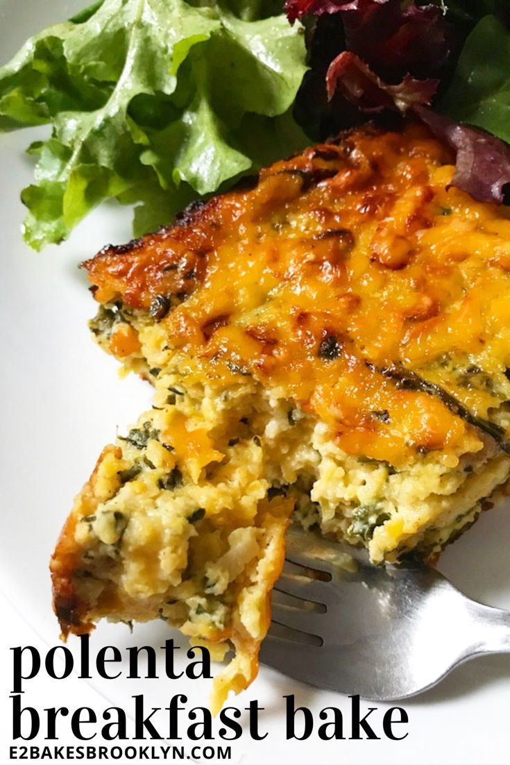 a white plate topped with a slice of quiche next to a leafy green salad