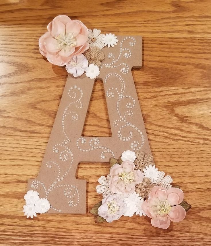 the letters are made out of cardboard and decorated with flowers