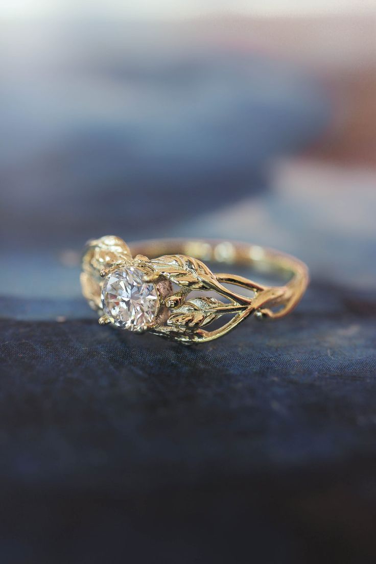 a close up view of a gold ring with a diamond on it's side