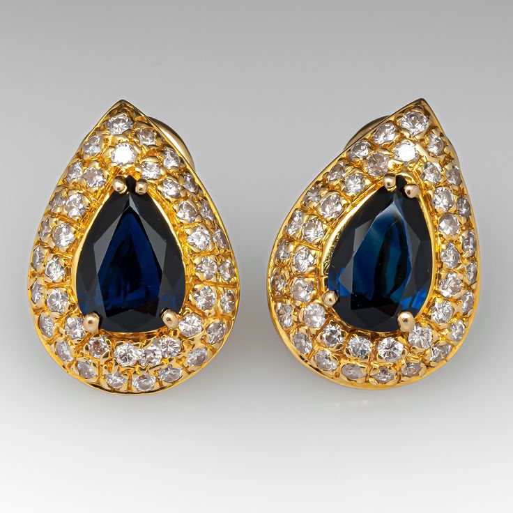 These gorgeous sapphire earrings are each centered with a pear cut sapphire in a four-prong setting. The center is accented by forty (40) bead set, round brilliant cut diamonds. The earrings measure 18.9mm long by 13.6mm wide and 6.2mm deep, finished with omega style clip on backs. We can add a post for pierced ears if you prefer. Blue Sapphire Earrings, Sapphire And Diamond Earrings, Jewelry Design Inspiration, Vintage Sapphire, Bead Set, Baguette Cut Diamond, Sapphire Earrings, August Birth Stone, Jewellery Design