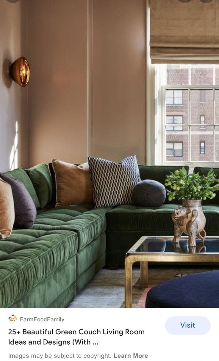 a living room filled with green couches and pillows on top of a coffee table