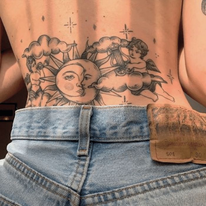 the back of a person's stomach with tattoos on it