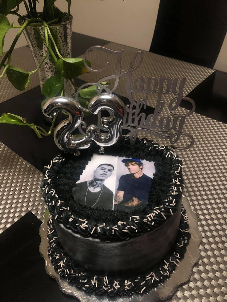 a birthday cake with an image of two people on it