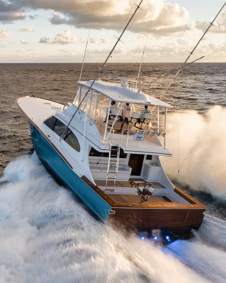 a white and blue boat in the ocean