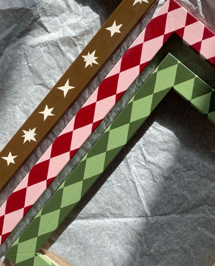 three pieces of cardboard are stacked on top of each other with stars and checkered designs