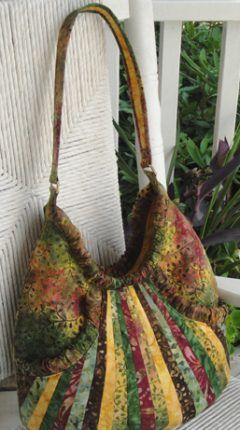 a multicolored purse sitting on top of a white chair