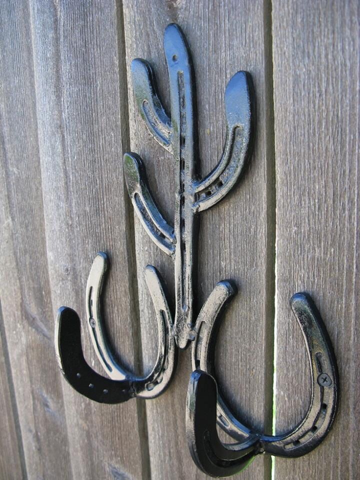 a metal hook on the side of a wooden fence