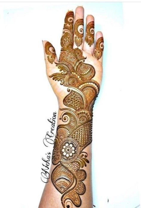 a woman's hand is decorated with hennap and intricate designs on it