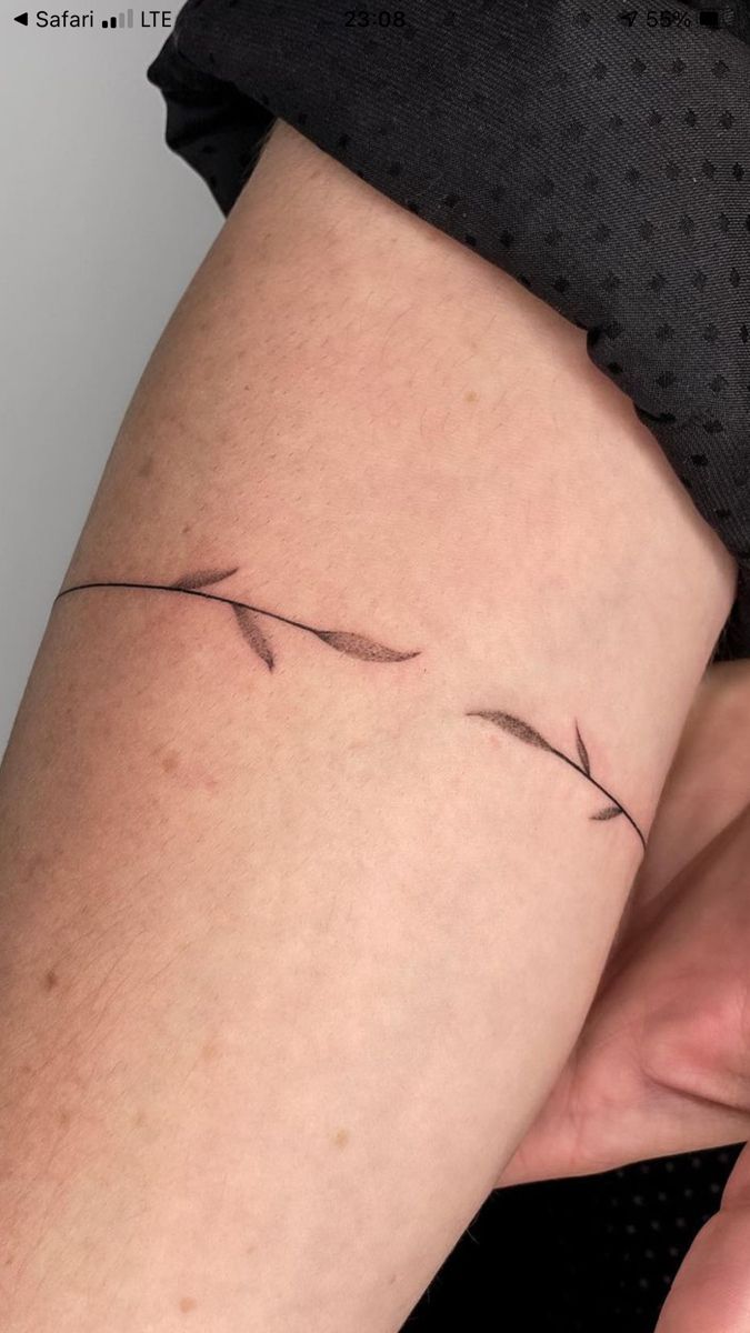 a woman's leg with a small tattoo on it