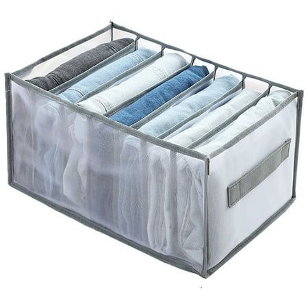 an open storage bin with four folded clothes in it on a white background, showing the bottom section