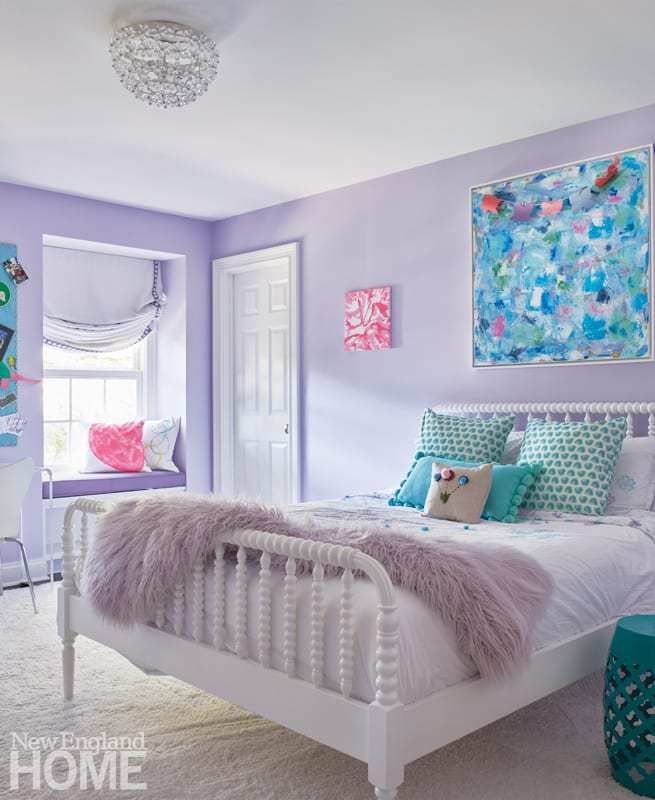 a bedroom with purple walls and white furniture