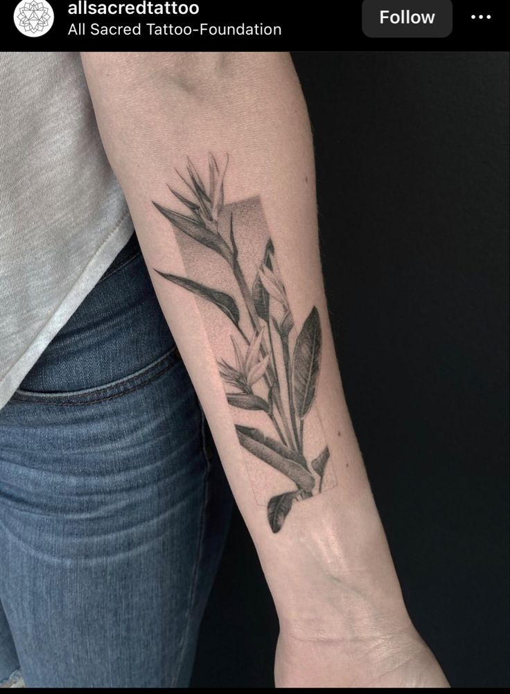 a woman's arm with a flower tattoo on it