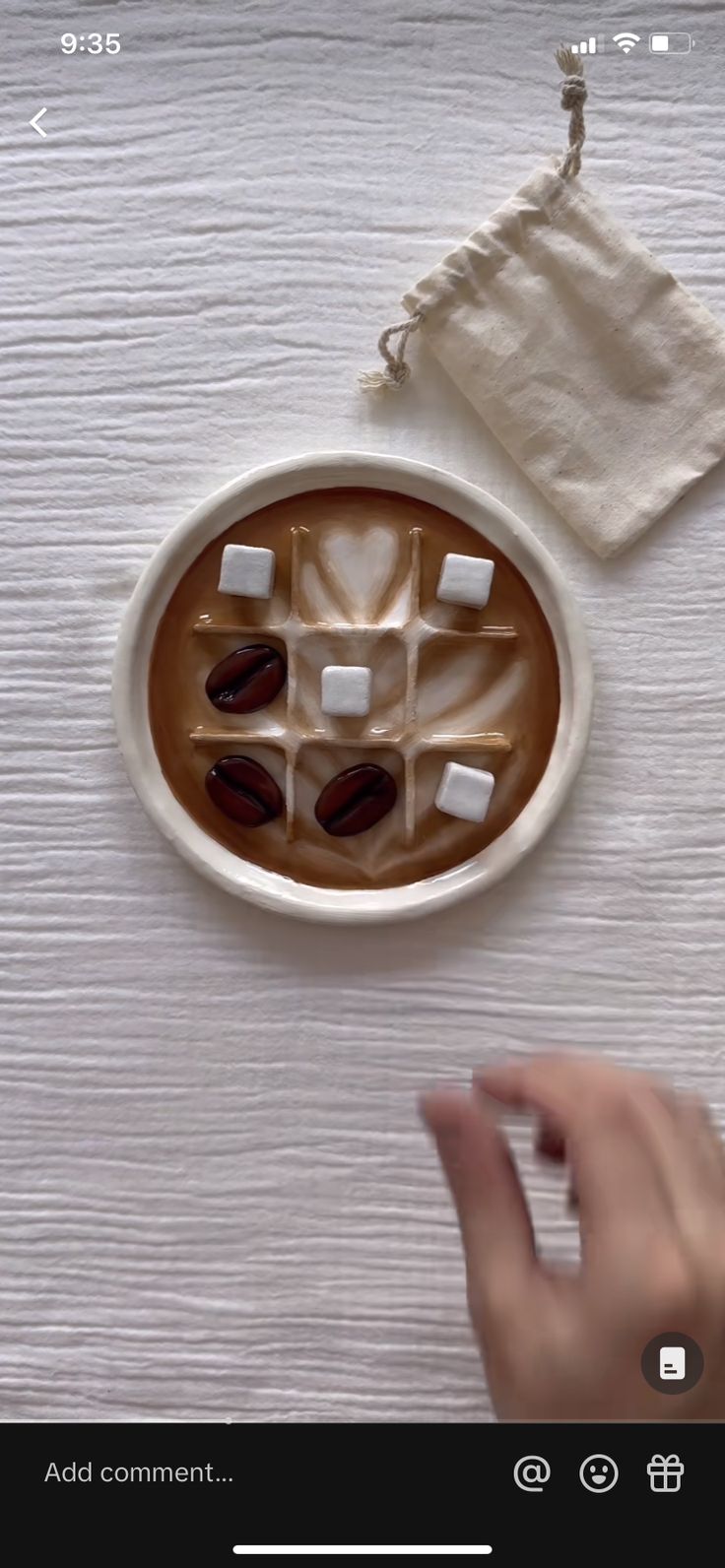 a cup of coffee with marshmallows in it on top of a table