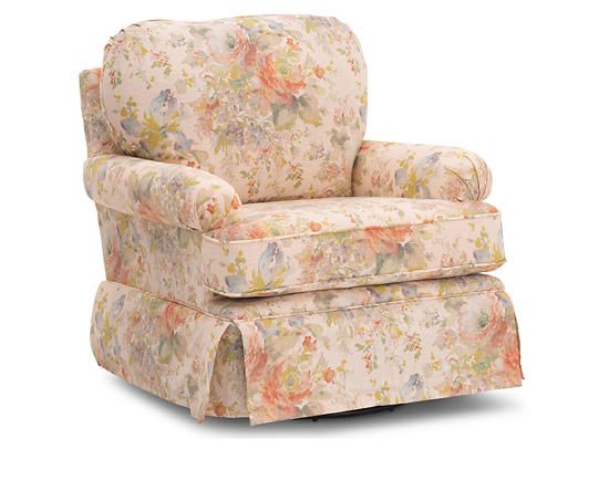 an upholstered chair with flowered fabric on the back and footrests