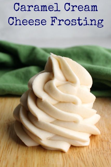 a close up of a cupcake on a wooden table with text that reads caramel cream cheese frosting