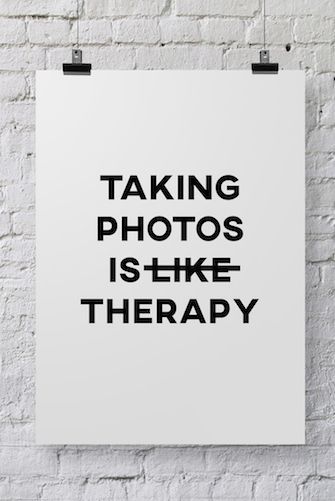 a black and white poster with the words taking photos is like therapy written on it