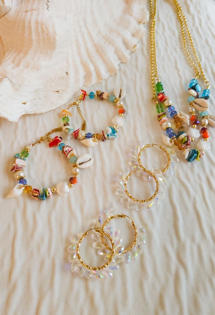 Embrace your inner beach babe with this unique bracelet. Featuring an eye-catching colorful beads design, steel beads, glass beads, and real sea shells, it's the ultimate must-have for all your seaside adventures. Add some beachy vibes to your style with this playful and one-of-a-kind bracelet! Ocean-inspired Beaded Bracelets For Beach, Gold Heishi Beads Jewelry For Vacation, Beaded Glass Bracelets For Beach, Bohemian Shell With Colorful Beads, Czech Glass Large Beads For Beach, Beach Beaded Heishi Bracelets, Beach-style Heishi Beaded Bracelets, Multicolor Shell Jewelry For Vacation, Beach Heishi Beaded Bracelets