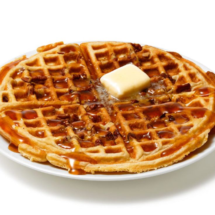 a waffle topped with butter and syrup on a white plate