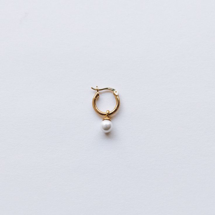 ~Made with 18K gold plated on sterling silver that gives it a charming sheen. ~Inner Hoop diameter: 10mm~Pearl Diameter: 6mm~Nickel Free & Lightweight, perfect for everyday wear ~Sold as 1 earring Hypoallergenic Yellow Gold Huggie Pearl Earrings, Classic Huggie Jewelry With Pearl Charm, Everyday Small Hoop Jewelry With Pearl Charm, Classic White Huggie Earrings For Everyday, Classic Gold Pearl Huggie Earrings, Gold Huggie Earrings With Pearl Charm, Gold Hypoallergenic Pearl Huggie Earrings, Everyday Pearl Charm Huggie Jewelry, Classic Pearl Huggie Jewelry