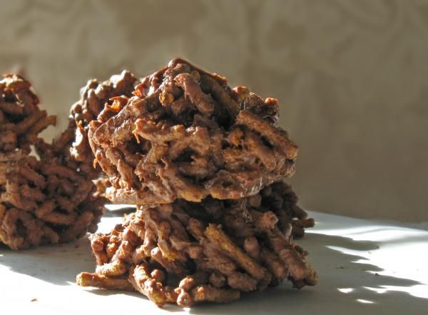 three cookies stacked on top of each other in front of a white wall and window