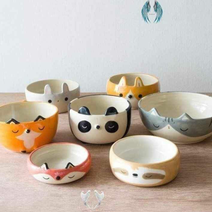 a group of small bowls sitting on top of a wooden table