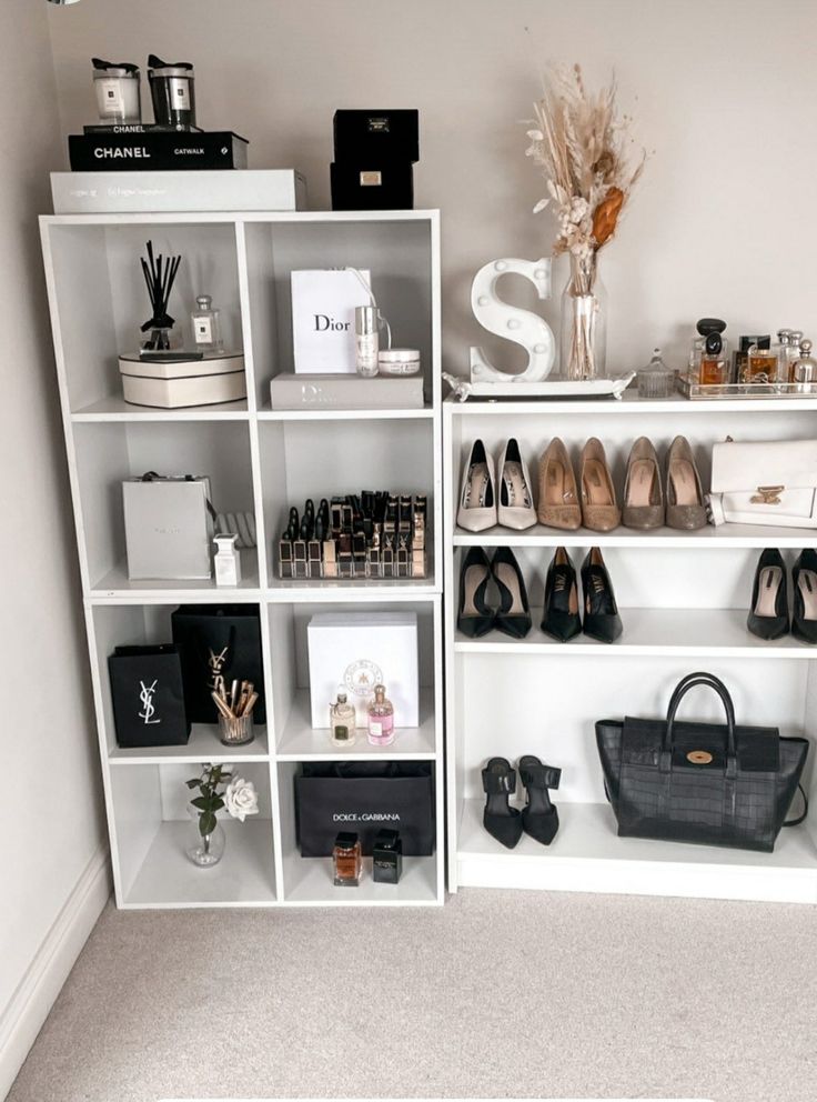 a white bookcase filled with lots of shoes and handbags on top of it