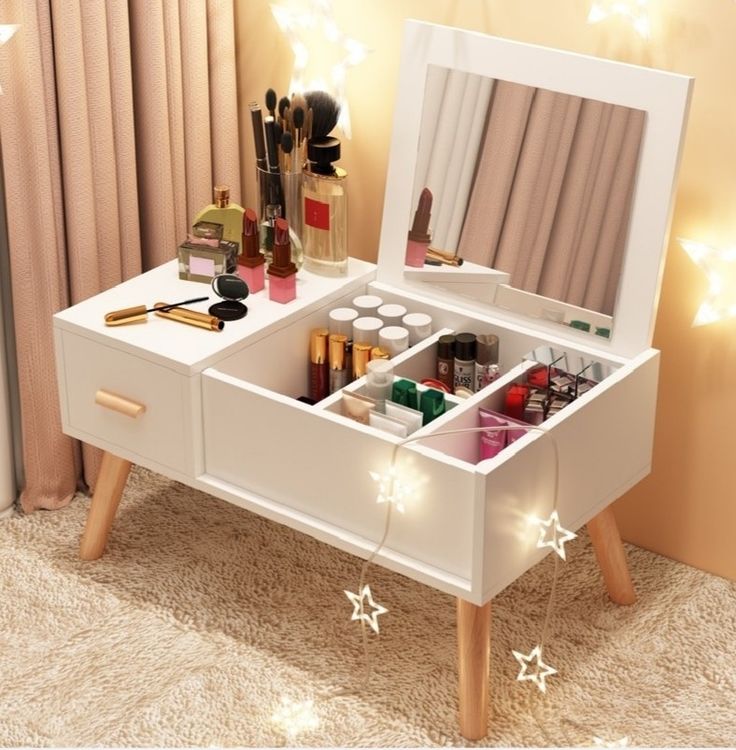 a white vanity with drawers and lights on the wall in front of it is decorated with stars