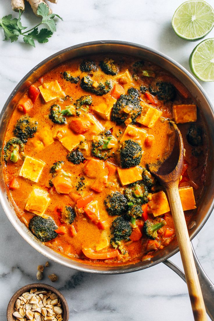 a pan filled with tofu and broccoli on top of a white counter