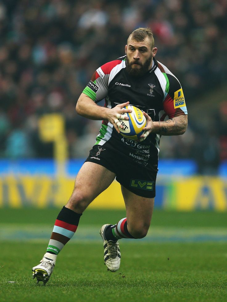 a rugby player is running with the ball