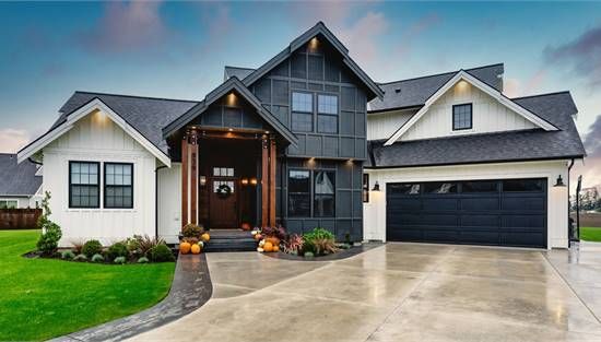 a large house with two garages and an attached driveway