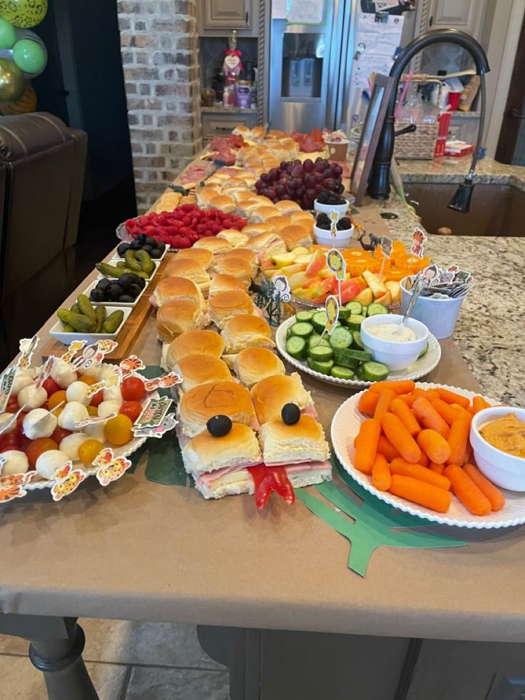 a long table filled with lots of different types of food on plates and bowls next to each other