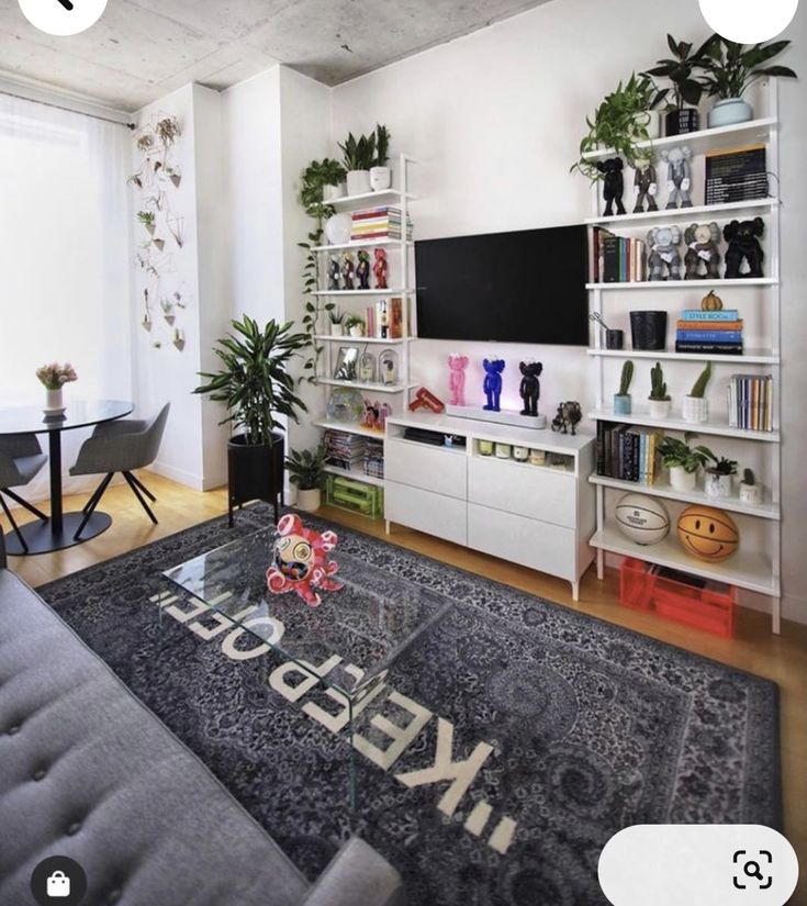 a living room filled with furniture and a flat screen tv on top of a book shelf